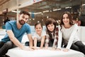 Big happy family testing orthopedic mattress in shop of furniture. Check softness of mattress. Royalty Free Stock Photo
