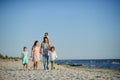 Big happy family walking at the beach.