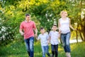 Big happy family walking in the beautiful park at sunset Royalty Free Stock Photo
