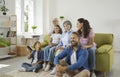 Big happy friendly family grandparents, parents and kids watching TV at home sitting on sofa. Royalty Free Stock Photo