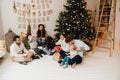 Big happy family exchanging gifts while sitting on floor near Christmas tree at home Royalty Free Stock Photo