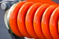 Big and hard orange steel spring as part and detail of industrial or agricultural machine Royalty Free Stock Photo