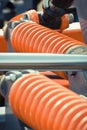 Big and hard orange steel spring as part and detail of industrial or agricultural machine Royalty Free Stock Photo