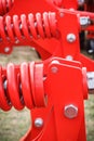 Big and hard red steel spring as part and detail of industrial or agricultural machine Royalty Free Stock Photo