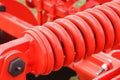 Big and hard red steel spring as part and detail of industrial or agricultural machine Royalty Free Stock Photo