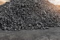 Big heap of dark black lump coal on floor bulk. Charcoal sorage at warehouse stock reserve. activated anthracite pile Royalty Free Stock Photo