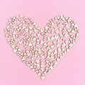 Big heart consists from many small hearts on pink background