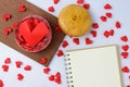 The big heart is in a jar hearts with paper hearts, notebook placed on the desk Royalty Free Stock Photo