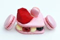 Big heart shape macaron and raspberry macarons on white background Royalty Free Stock Photo