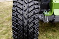 A big heavy new tire with a detailed tread on the grass Royalty Free Stock Photo