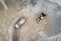 Big heavy wheel loader loading sand into dump truck in sand pit. Heavy industrial machinery concept Royalty Free Stock Photo