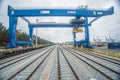 Big high blue steel railway crane with new modern railway in port of Gdansk