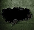 Big hole in military green metal armor background