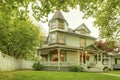 Big home with nice front yard, porch, white railings and walkway Royalty Free Stock Photo