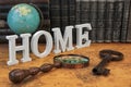 Big Home Sign Among Different Objects And Books On Map Royalty Free Stock Photo