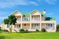 Big house - front view, grass, bench, tree