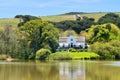 Big house next to lake and hills