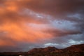 Big huge sunset clouds over the red mountains in Tucson Arizona