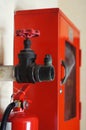 Big vintage Hydrant Valves install next to red Fire hose cabinet with part of Fire extinguisher Royalty Free Stock Photo