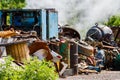 Illegal garbage dump. Large pile of metal, wooden and plastic waste. The concept of ecology pollution.