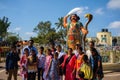 Big Indian family posing in front of Statue of Mahisasura holding a snake and a sword