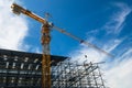 Construction crane tower on blue sky background.