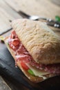 Big italian sandwich. Salami sandwich Royalty Free Stock Photo