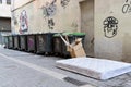 Big items left on a pedestrian street near garbage bins