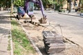 Big jackhammer drill drilling road.Heavy machinery crushing asphalt for stormwater drain repair. excavator tracks in the Royalty Free Stock Photo