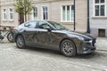 Dynamic Mazda 6 sedan car parked on an old street