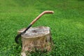 The big knife with long wooden handle on the tree stump Royalty Free Stock Photo