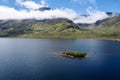 Big lake by a mountains with small island. cloudy sky. Blue water color. Connemara, Ireland. Irish landscape scene. Travel and Royalty Free Stock Photo