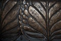 Big leaves close-up macro dark bronze metal relief background.