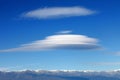 Big lenticularis cloud and snowed mountain