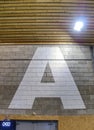 Big letter painted on brick hall wall for devide room for sections