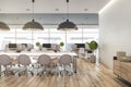 BIg light conference table in the center of modern open space office with wooden floor and furniture and city view Royalty Free Stock Photo