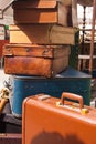 Piles of old suitcases on the table of the stall