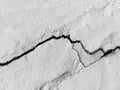 Big long tortuous crack on old plastering wall. Copy space. Black and white photo.