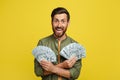 Big luck and win concept. Portrait of happy man holding a lot of dollar cash, celebrating success and posing with money Royalty Free Stock Photo