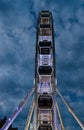 Big luminous ferris wheel in front of dark blue dramatic sky Royalty Free Stock Photo