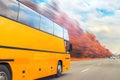 Big luxury comfortable tourist bus driving through golden autumn tree highway on bright sunny day. Blurred motion.Travel and coach Royalty Free Stock Photo