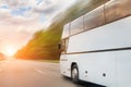 Big luxury comfortable tourist bus driving through highway on bright sunny day. Blurred motion road. Travel and coach Royalty Free Stock Photo