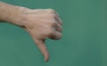 Male thumb down on green background Royalty Free Stock Photo