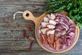 Big meat set. Homemade smoked pork-beef sausage, salted bacon, basturma chopped slices on a wooden board with spices and herbs Royalty Free Stock Photo