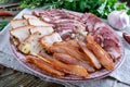 Big meat set. Homemade smoked pork-beef sausage, salted bacon, basturma chopped slices on a wooden board with spices and herbs Royalty Free Stock Photo