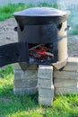 Big metal cauldron pot on movable stove outdoors