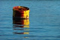 Big metal painted buoy in floating water Royalty Free Stock Photo