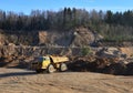 Big mining truck transportion sand in the open-pit. Heavy machinery in the mining quarry, excavators, dozers and trucks. Digging