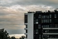 Big modern building with large windows in Paris against a gloomy cloudy sky Royalty Free Stock Photo