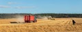 Big modern tractor trucker machine with full loaded with grain or silage wagon container trailer harvested wheat field Royalty Free Stock Photo